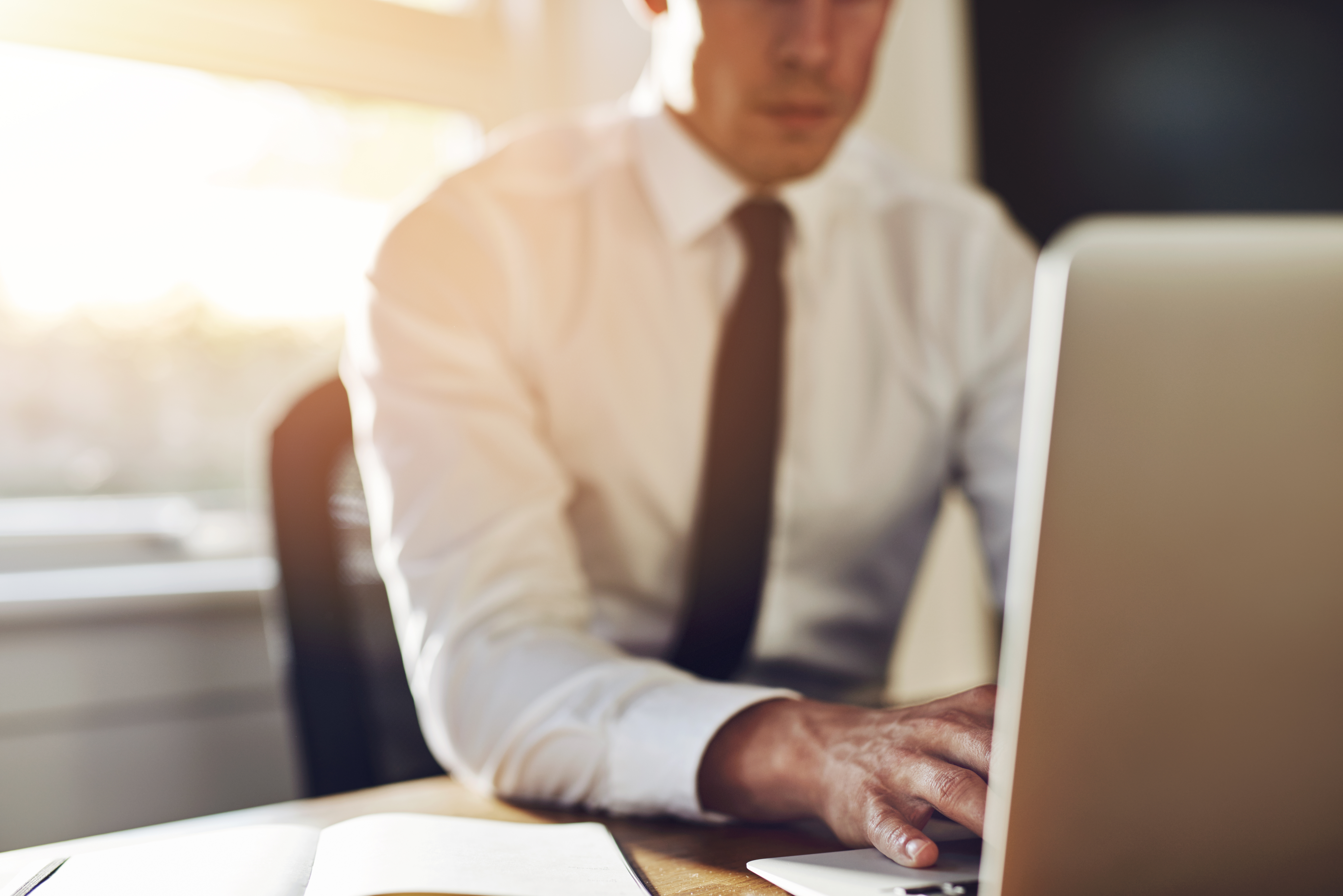 Business close up, executive working on laptop while sitting at office